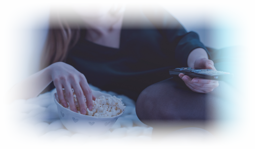 woman eating popcorn in bed with insomnia